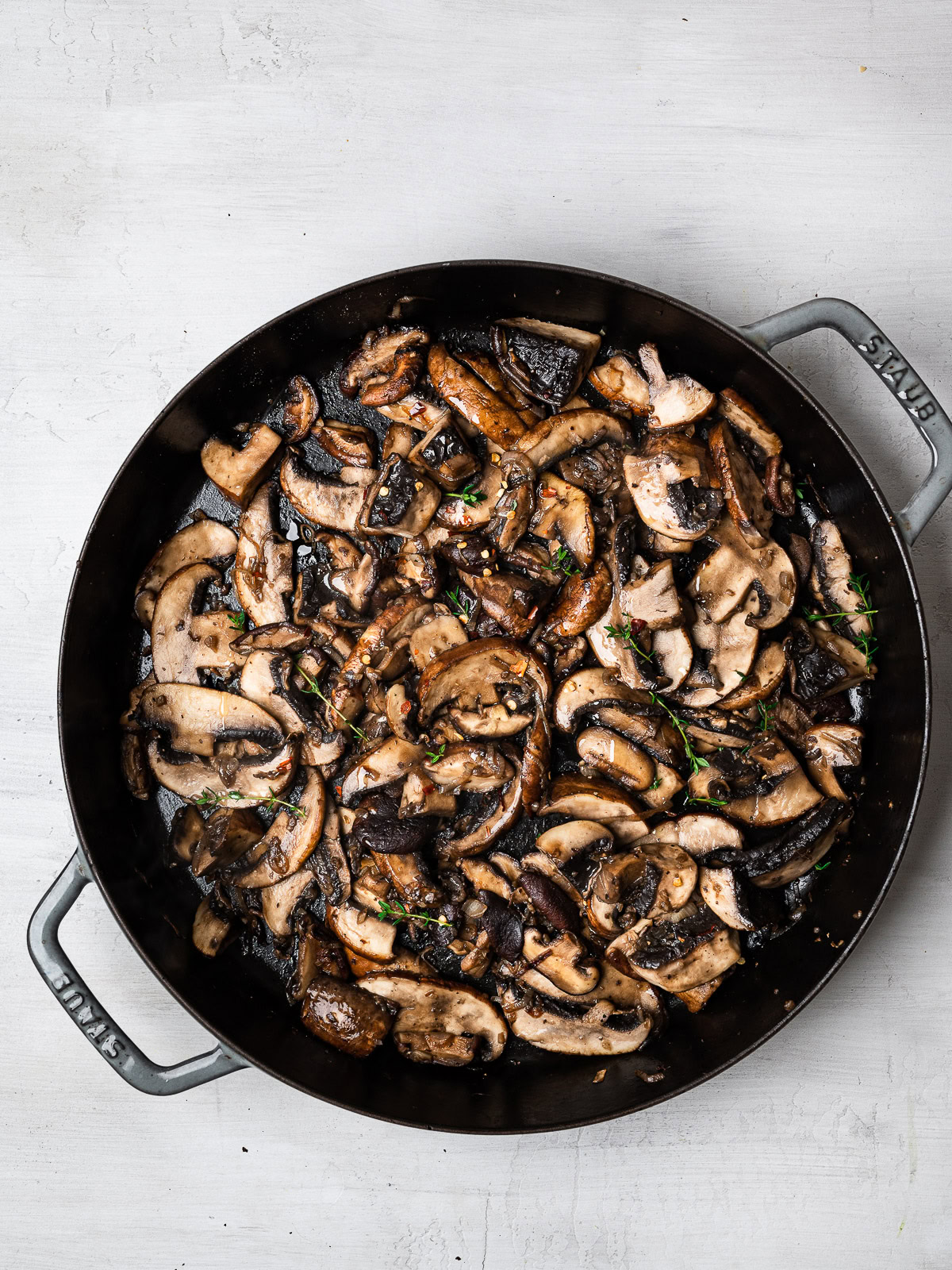 sliced mushrooms sautéing in skillet