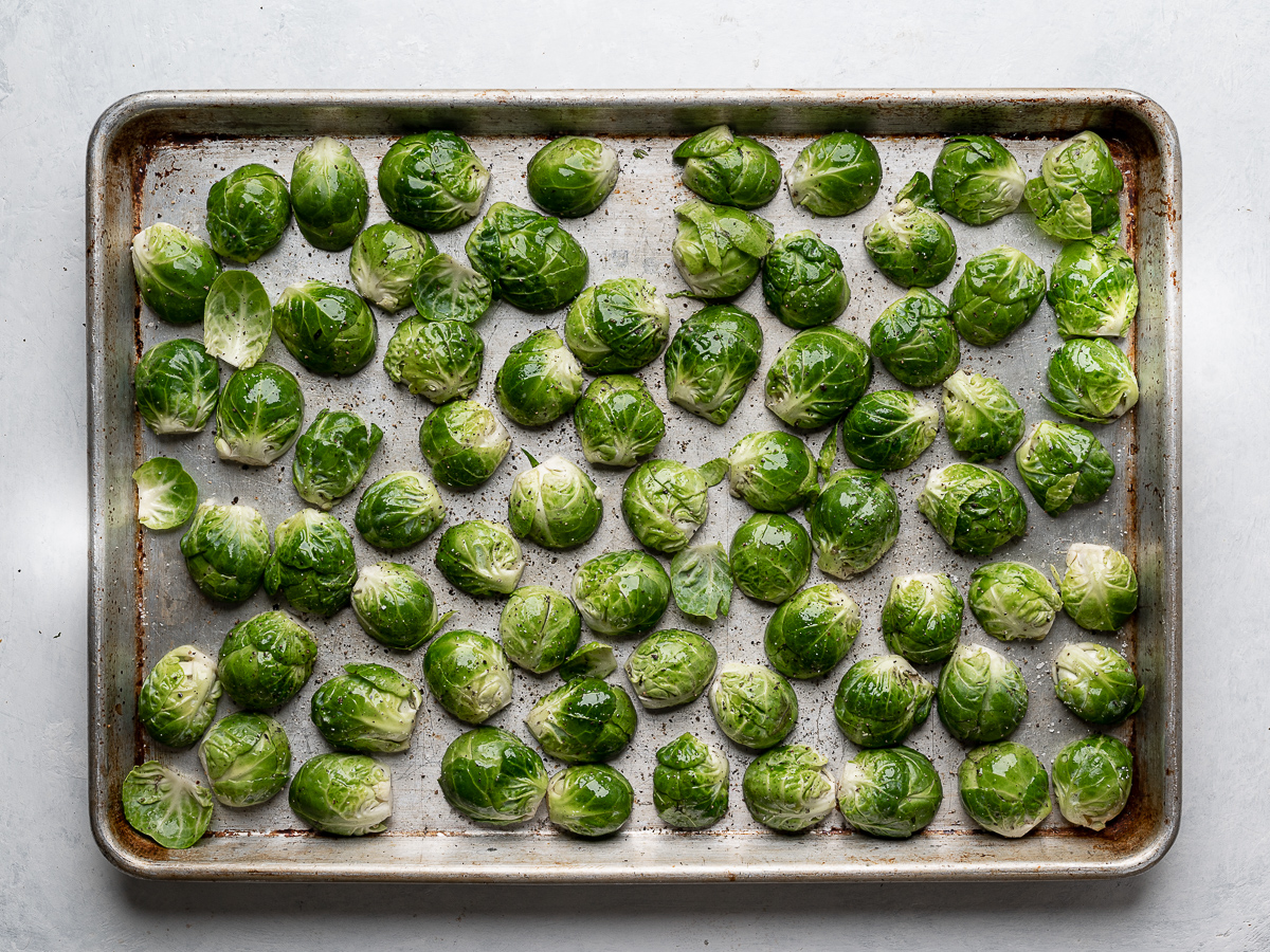 evenly layered sprouts on sheet pan ready to be roasted