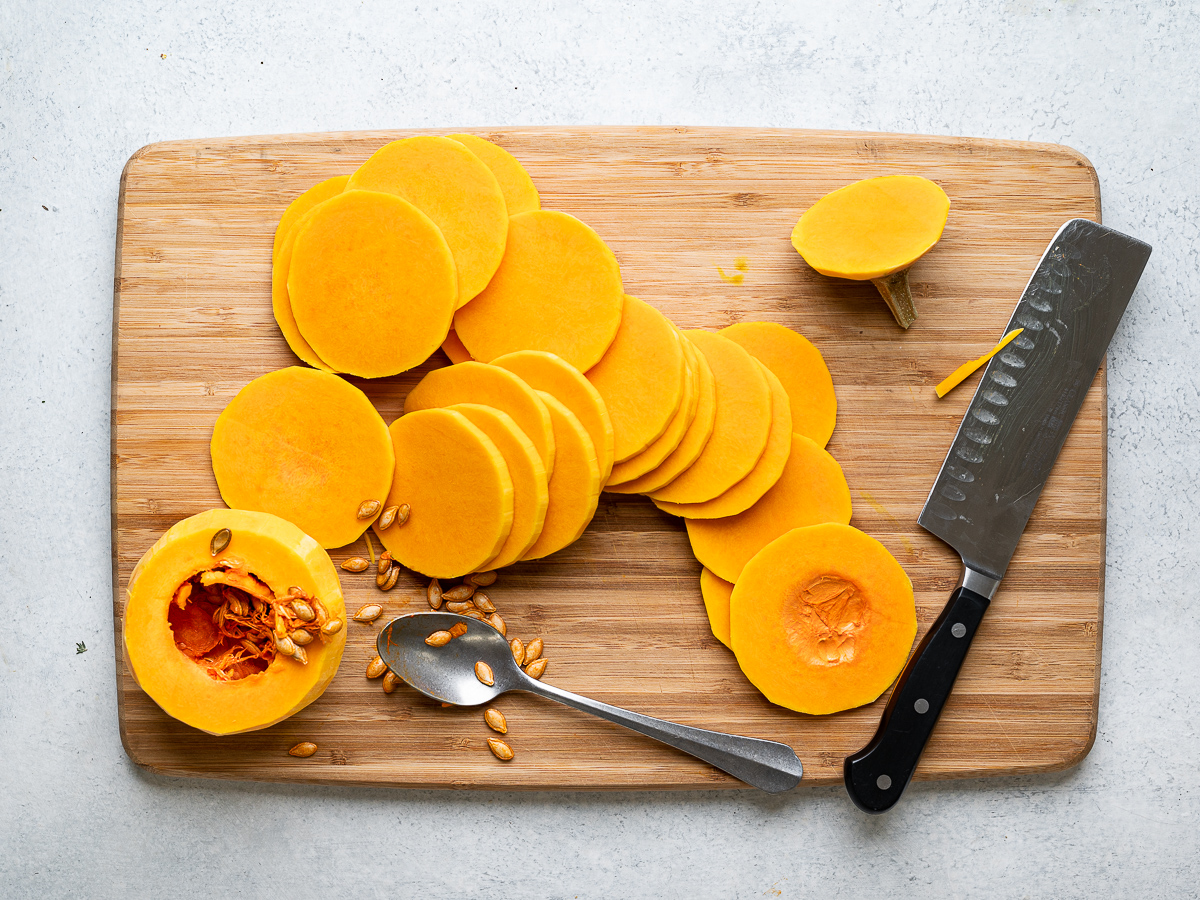 slicing butternut squash on cutting board