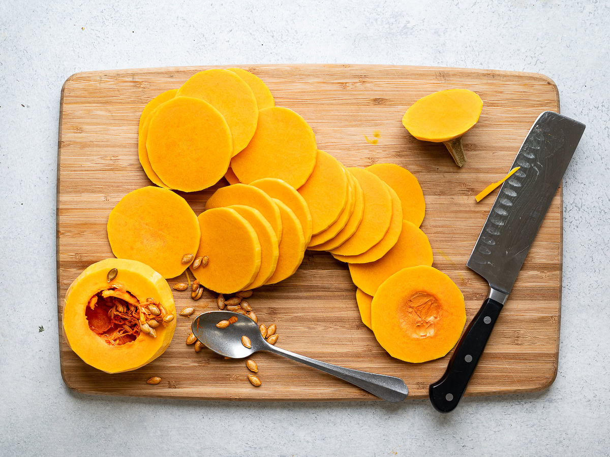 slicing butternut squash on cutting board