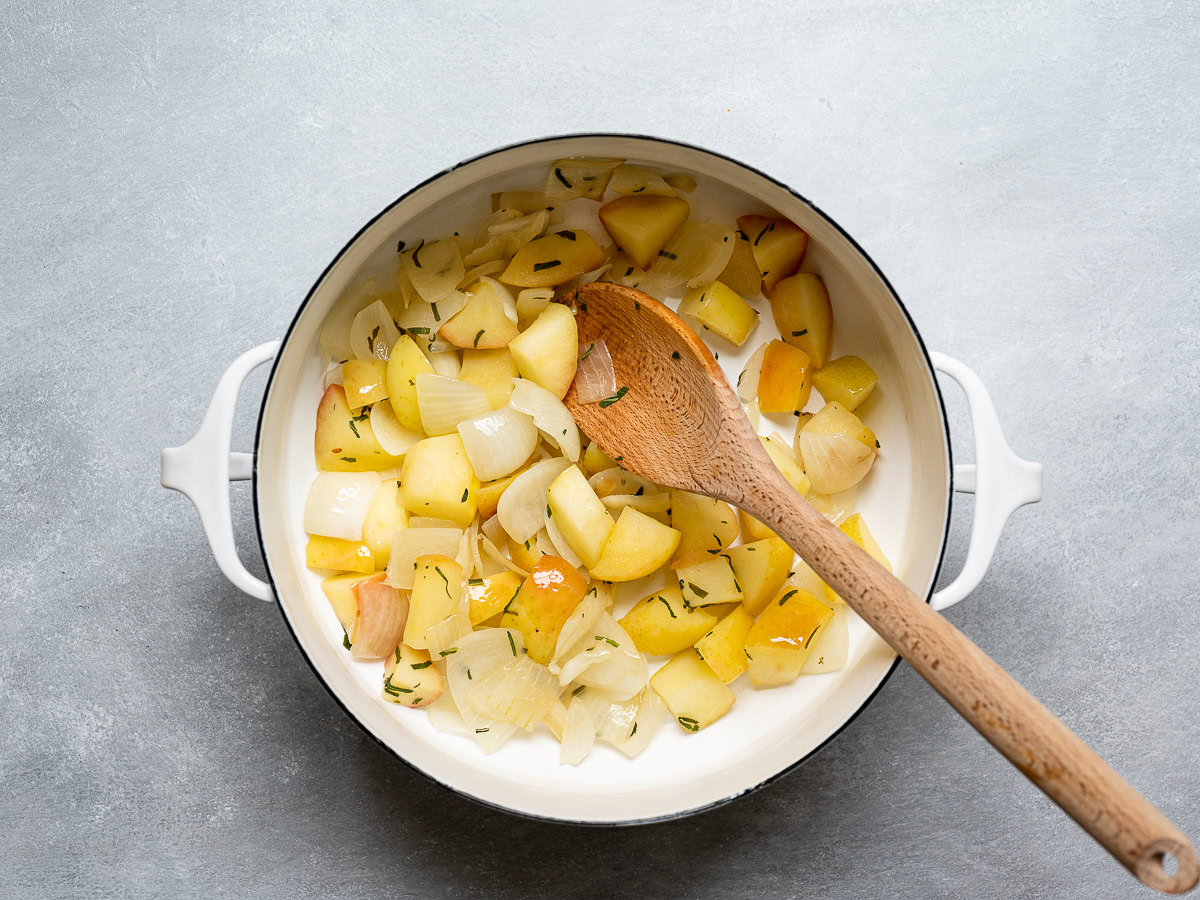 aromatics and apples stewing in pot