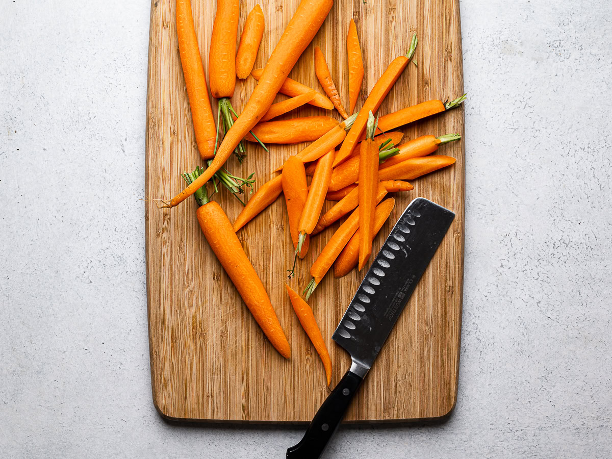 chopping the carrots on cutting board