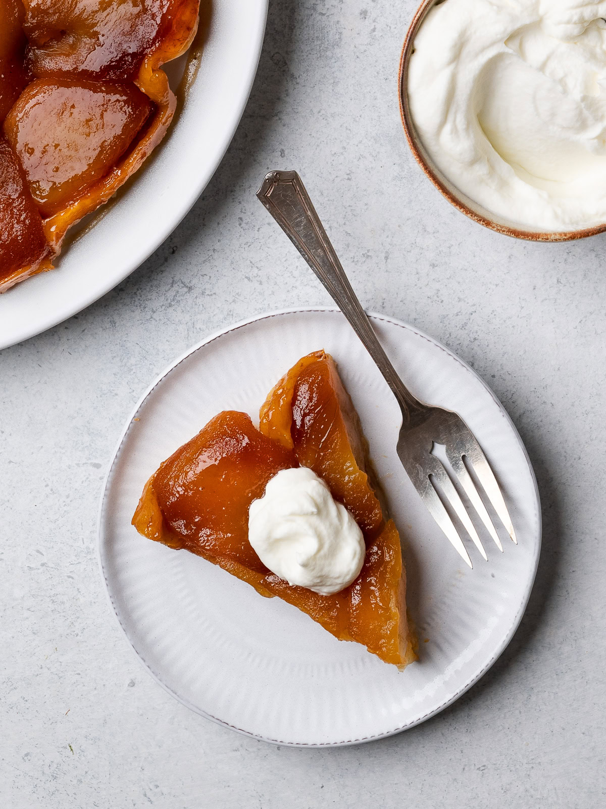 piece of tart on plate with whipped cream on top