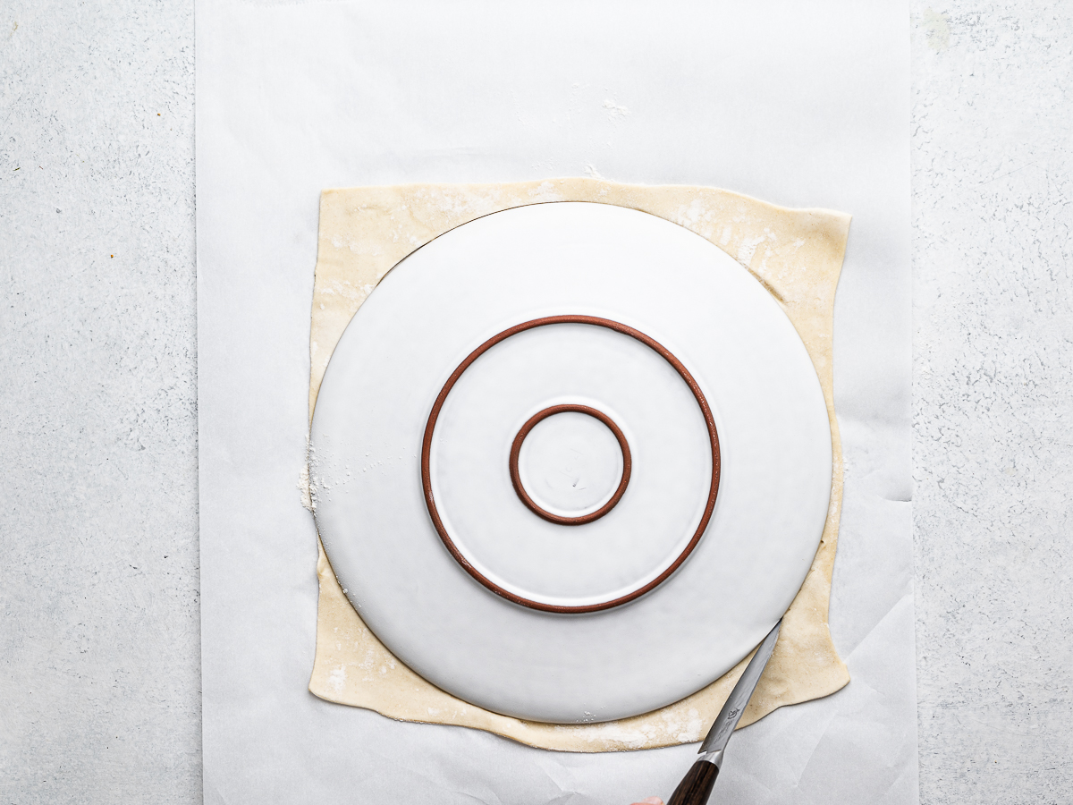 cutting puff pastry into a circle using a plate as template