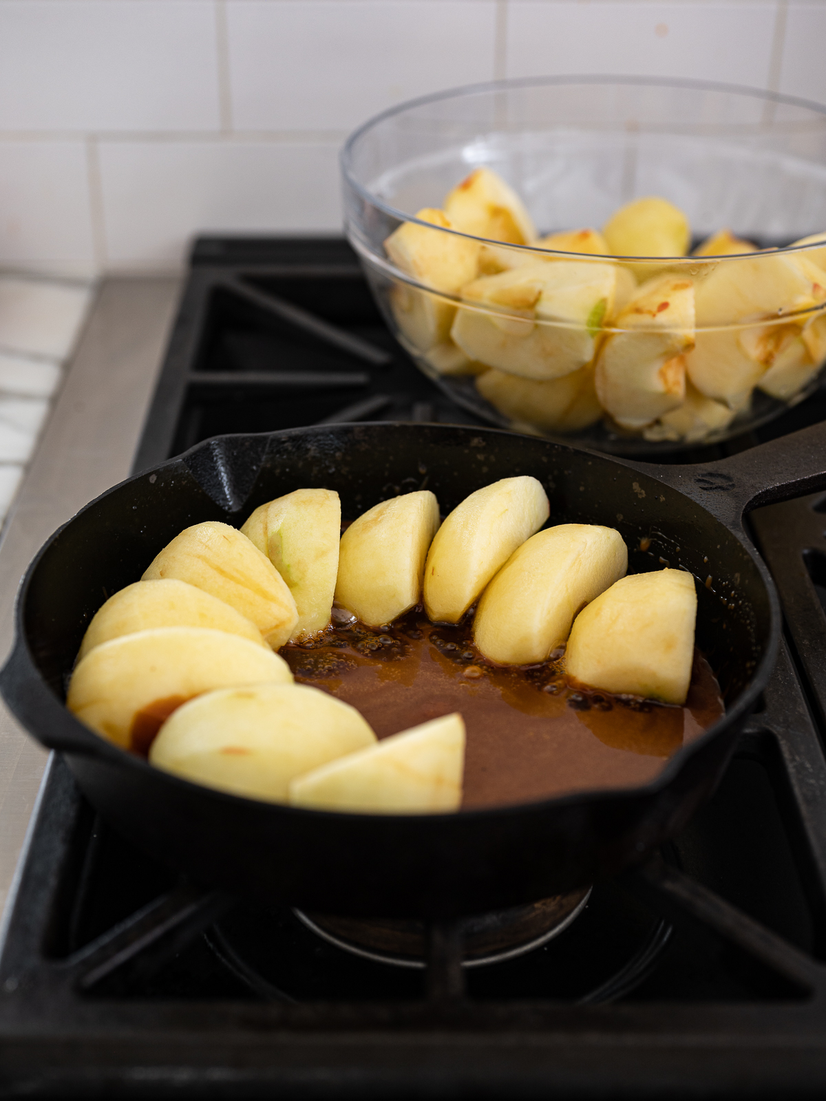 arranging apples in skillet with caramel
