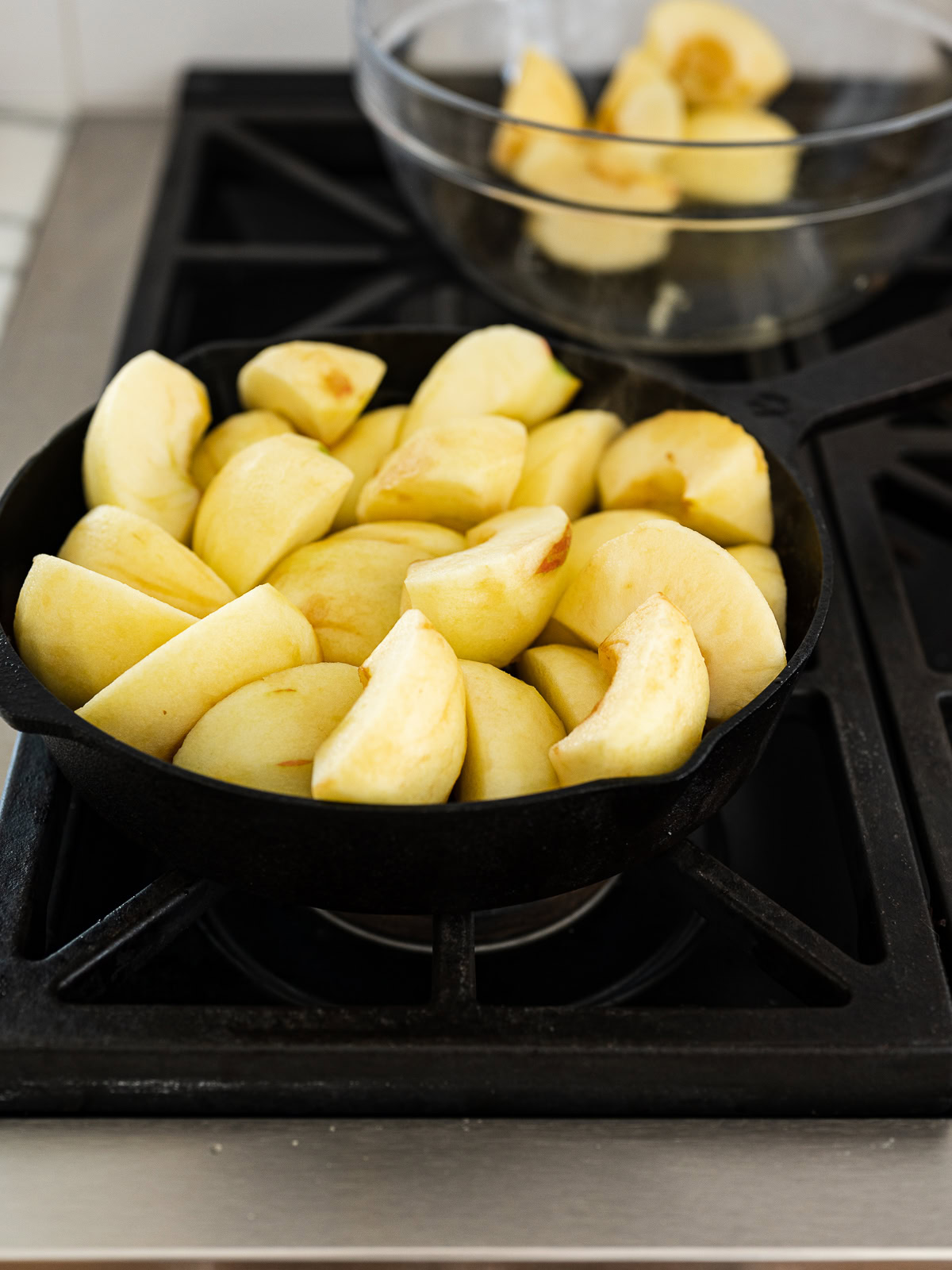 image of all the raw sliced apples crammed in skillet 