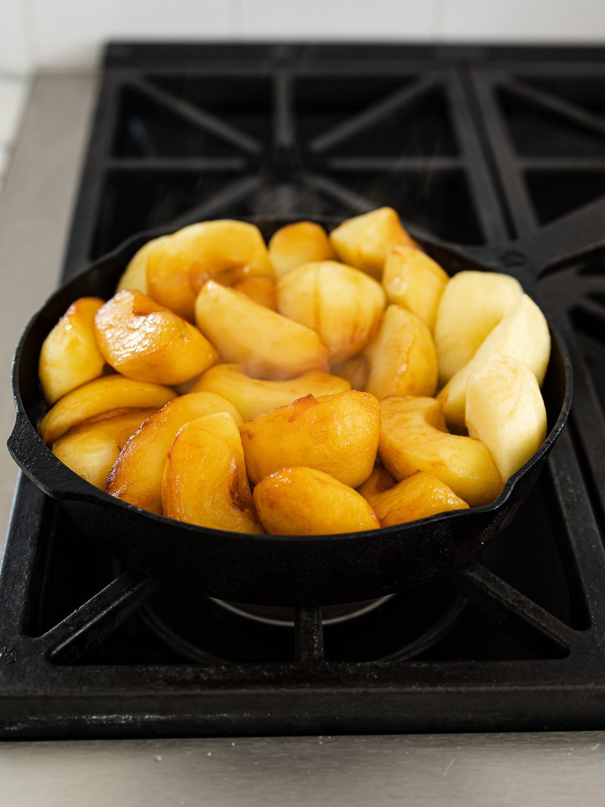 apples in skillet cooking in caramel