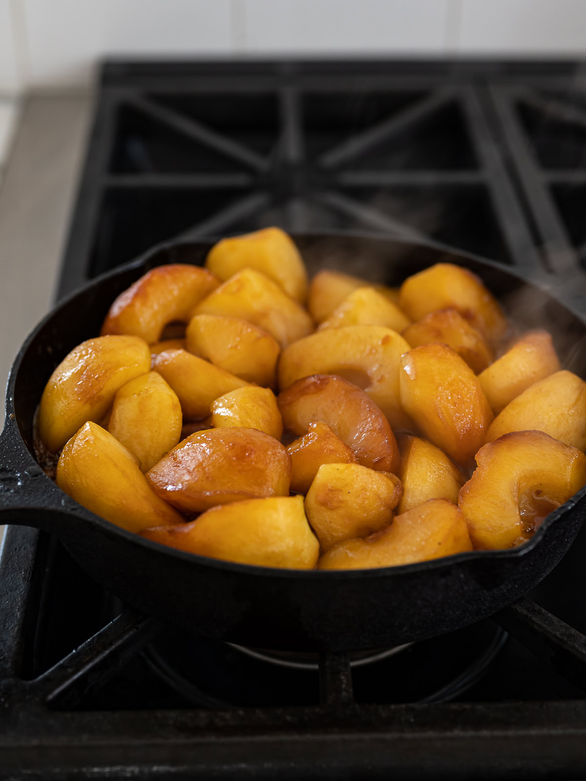 Apple pieces cooked down in skillet with caramel