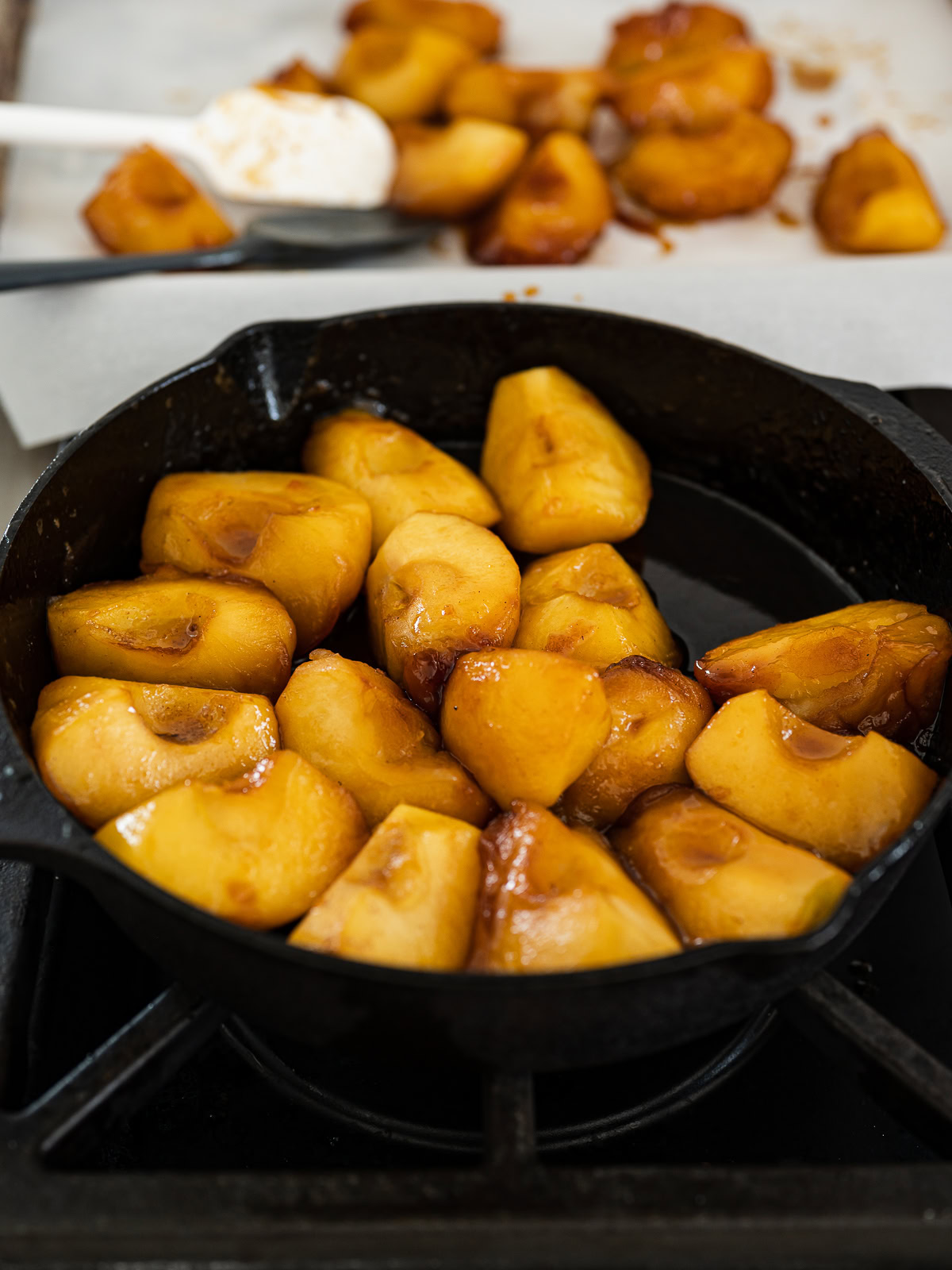 arranging apple pieces in skillet in a concentric circle