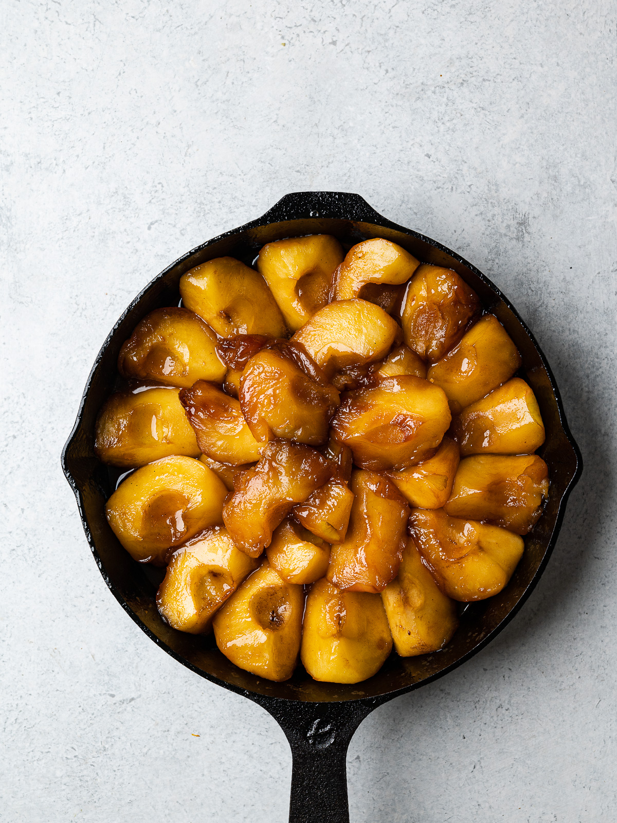 top-view image of apples arranged in skillet right before baking 