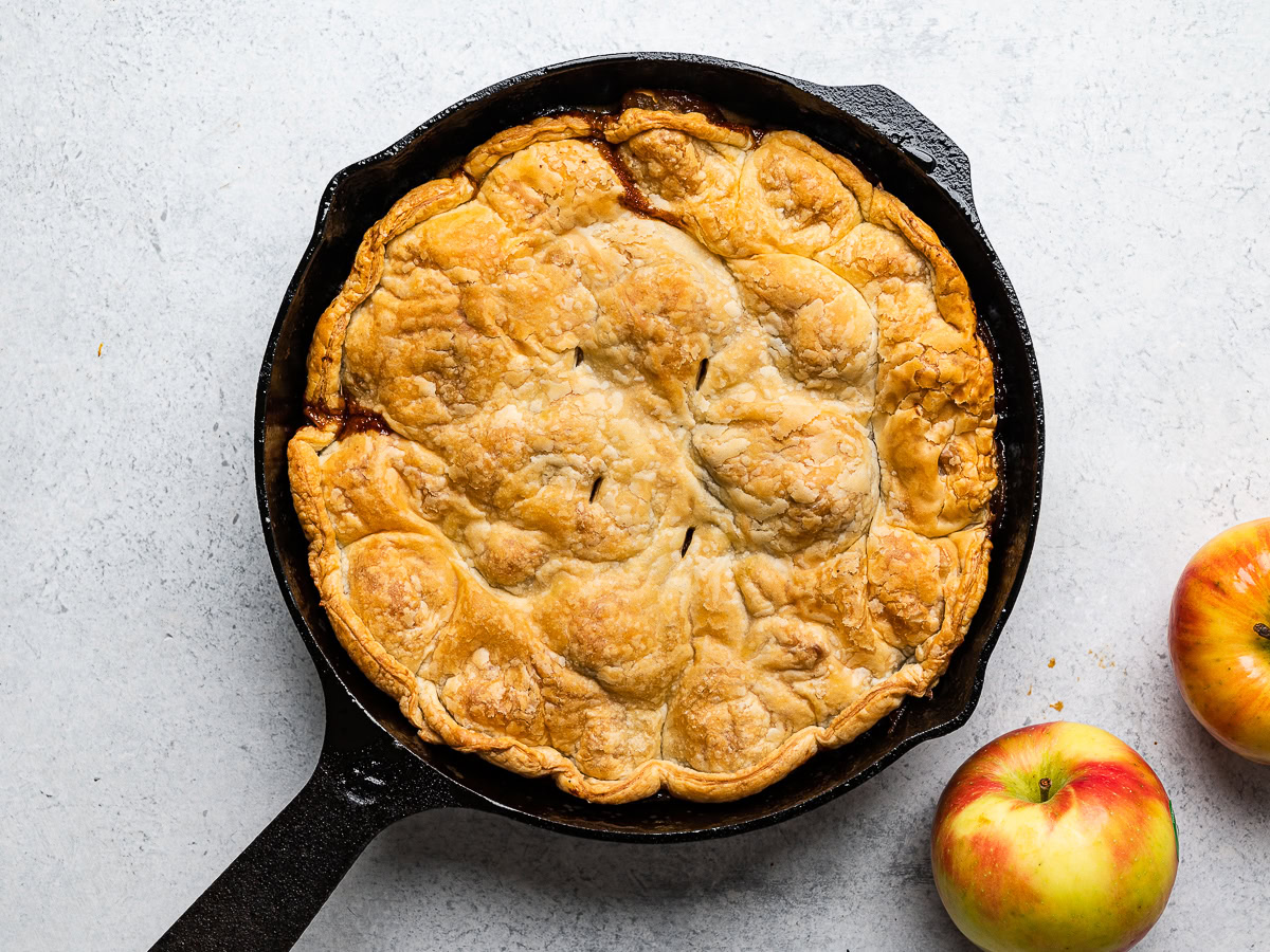 baked apple tarte tatin still in skillet showing golden crust on top