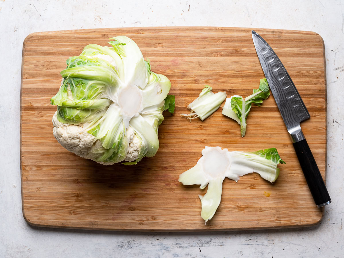 cutting the bottom off the cauliflower