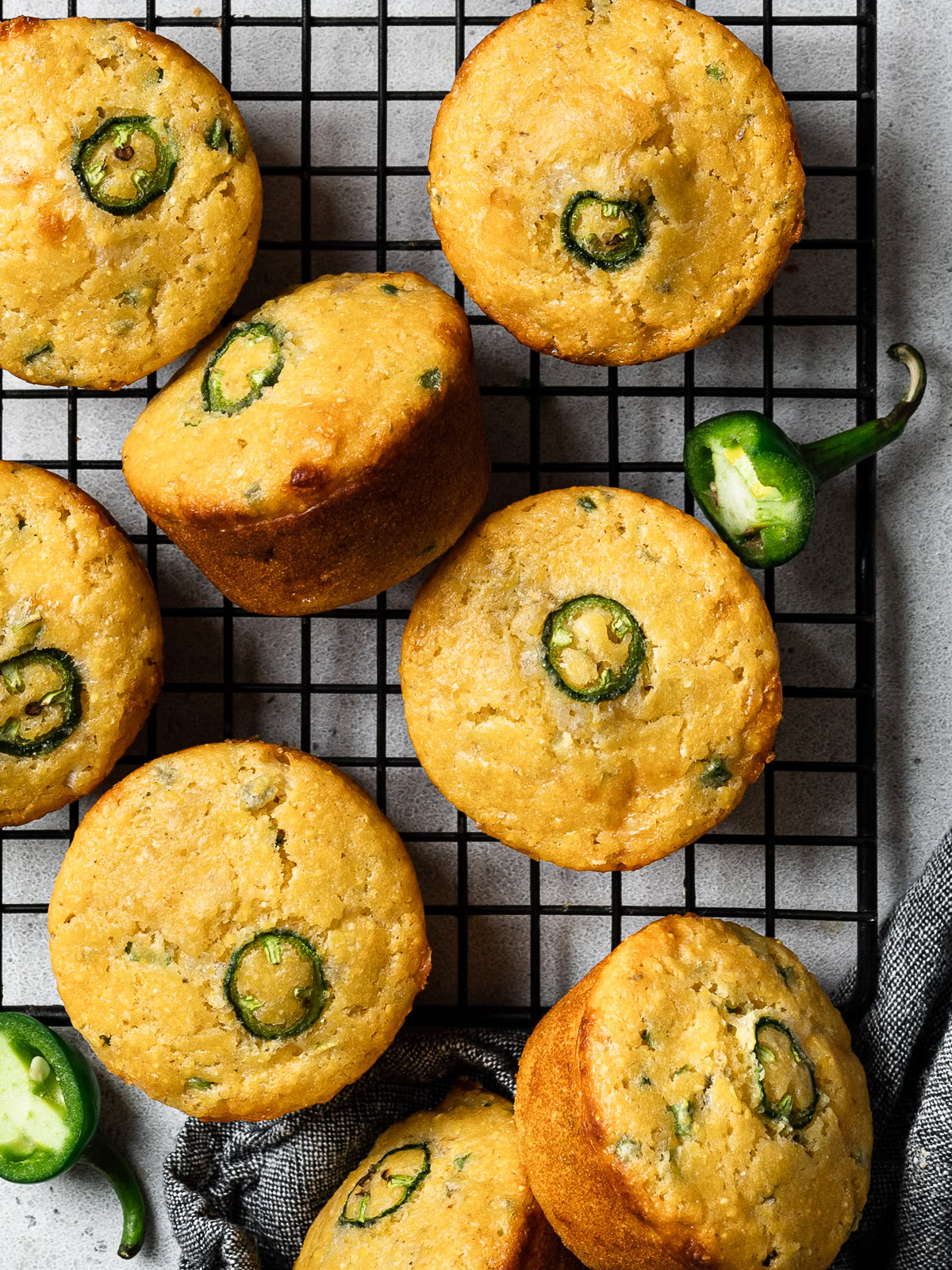 baked jalapeño cornbread muffins cooling on rack