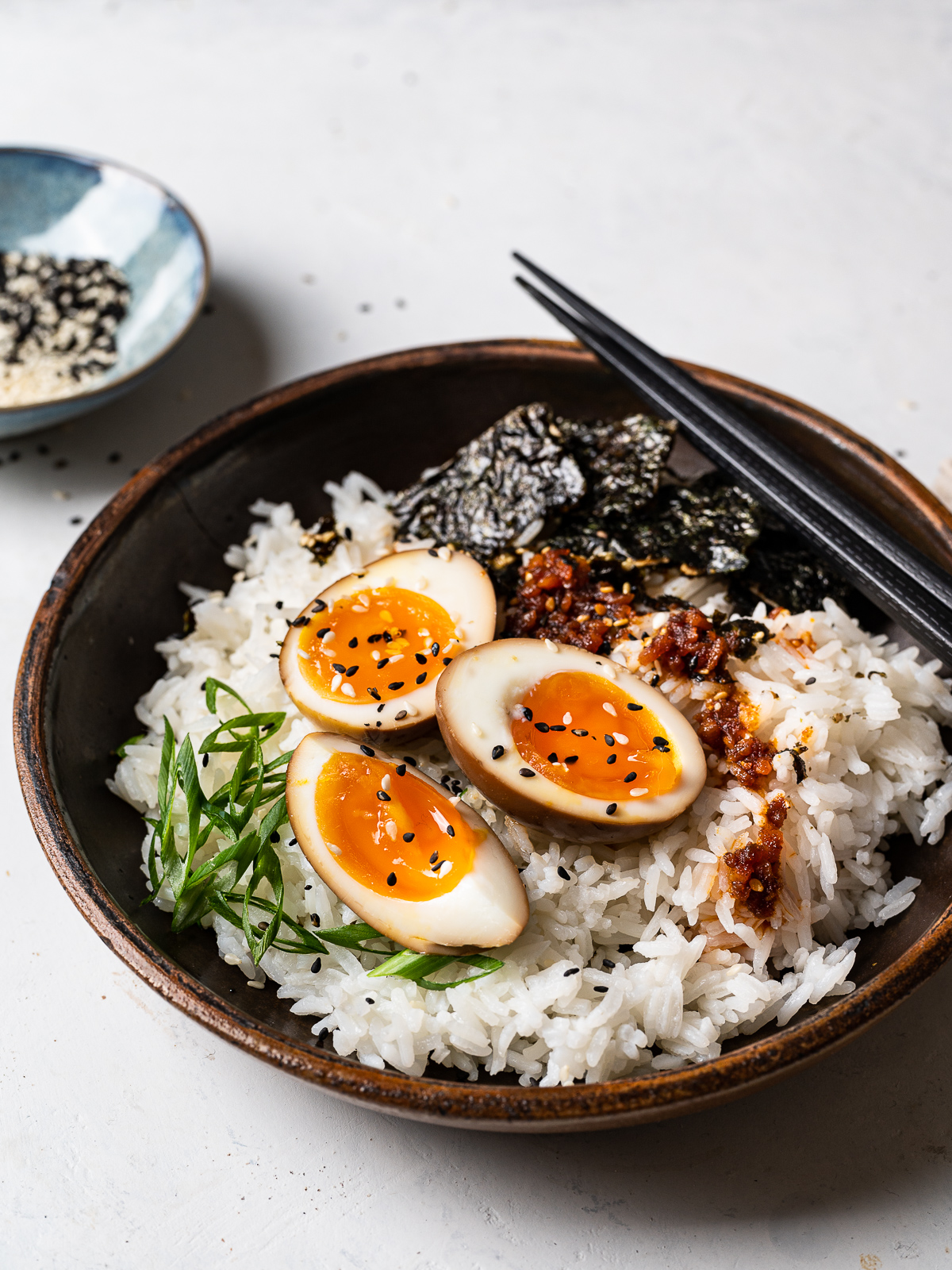 soy sauce eggs topping white rice in a bowl