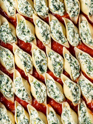 A close up of Spinach ricotta Stuffed shells before baking