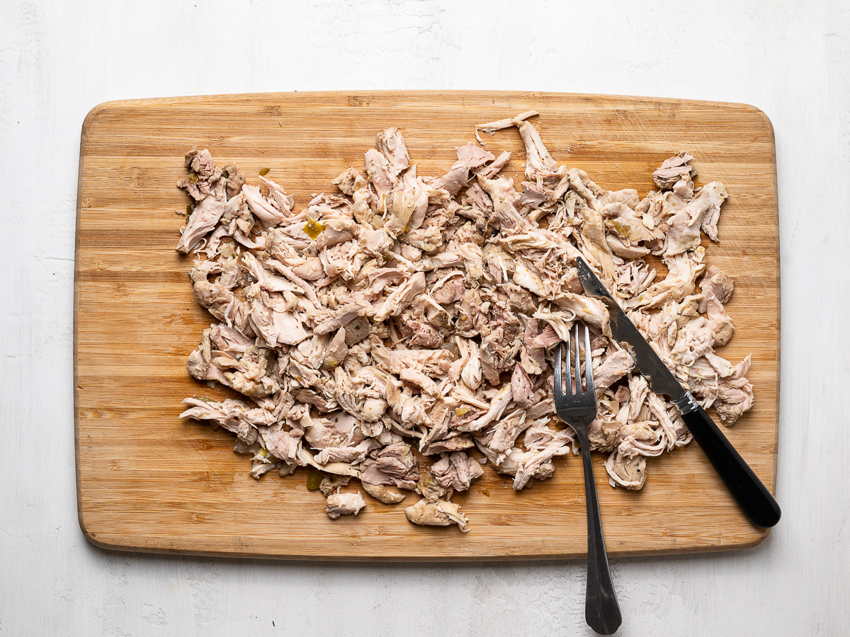 shredded chicken on cutting board