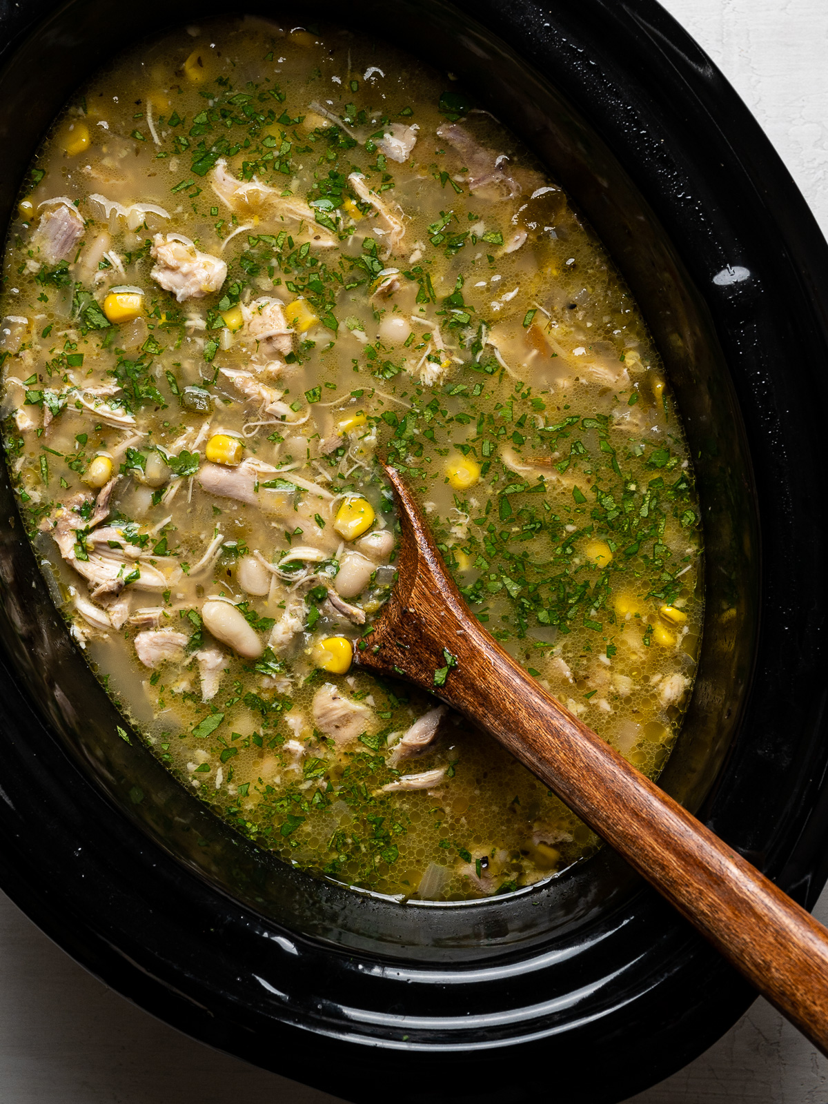 close up of white chicken chili in slow cooker
