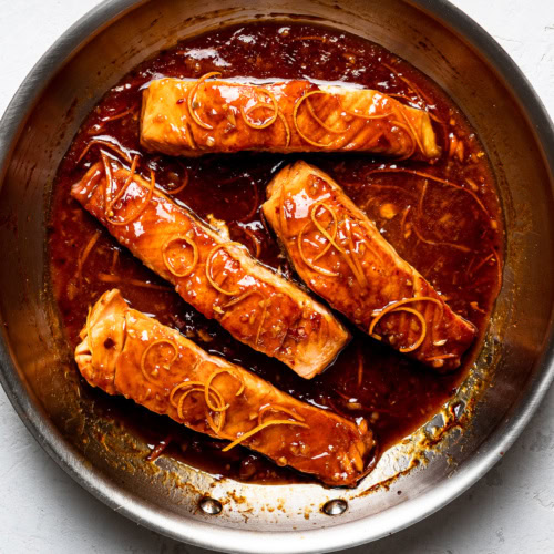 salmon in pan with tangerine sauce