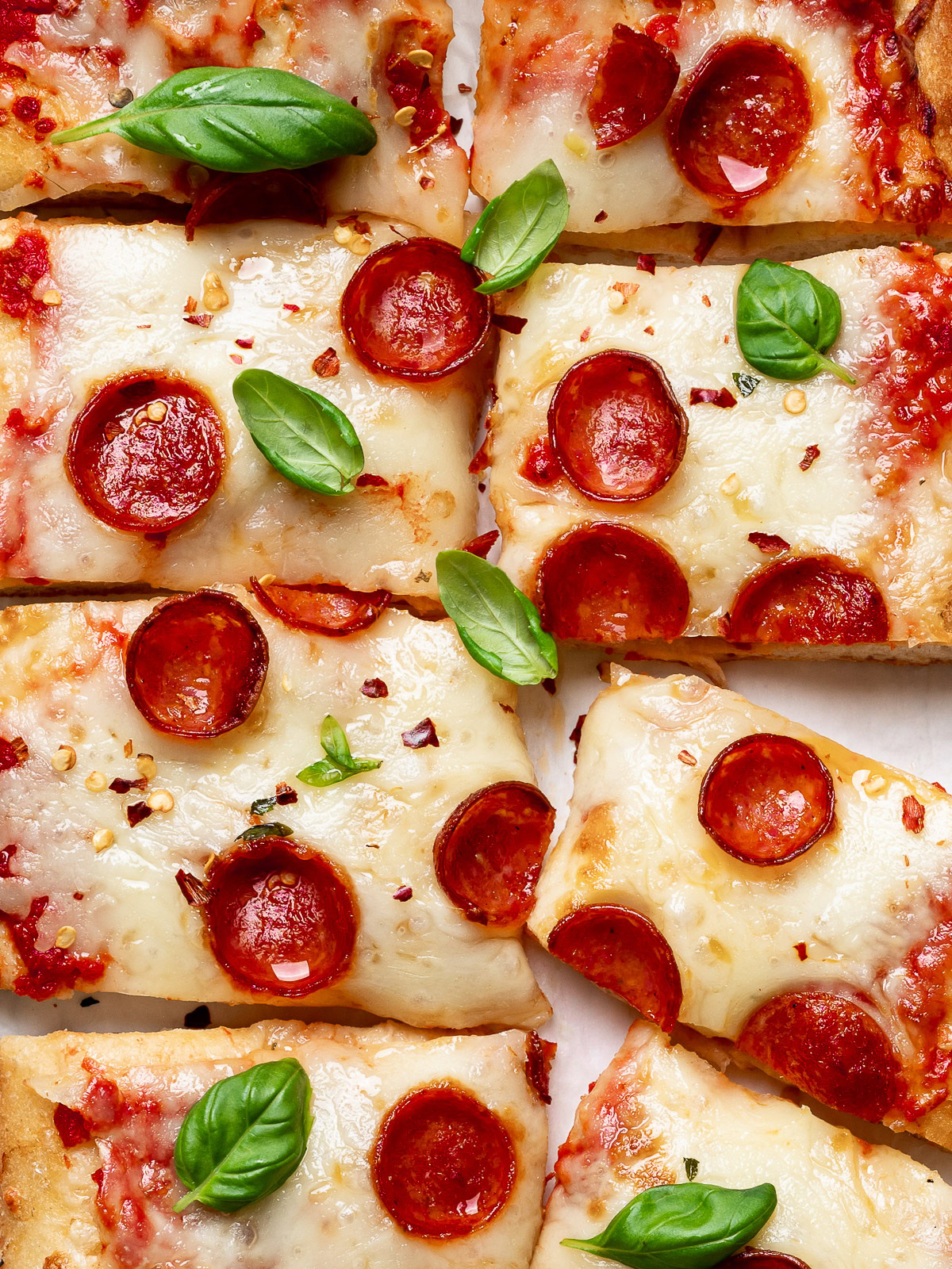 close up of sliced Flatbread Pizza with cheese, pizza sauce, and pepperoni