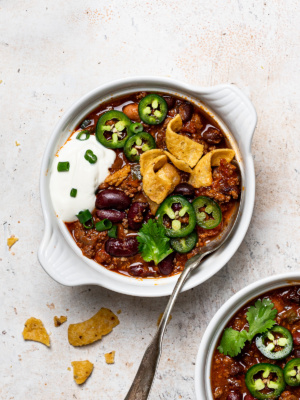 Game day chili served in a bowl with toppings