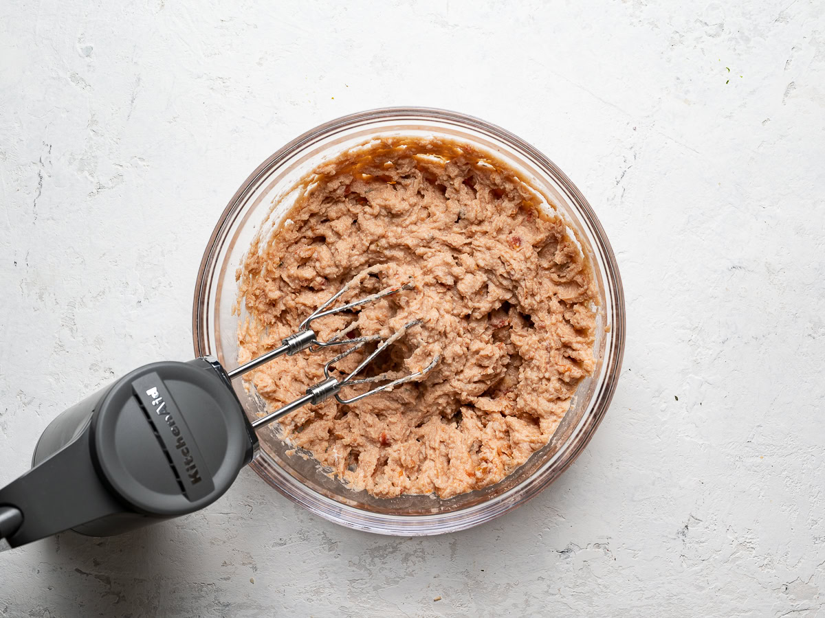 mixing refried beans and salsa with Hand mixer