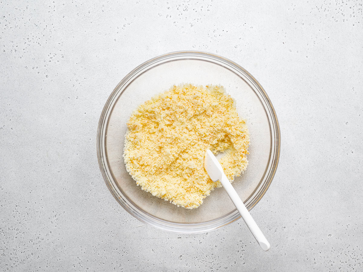 sugar and orange zest mixed in bowl