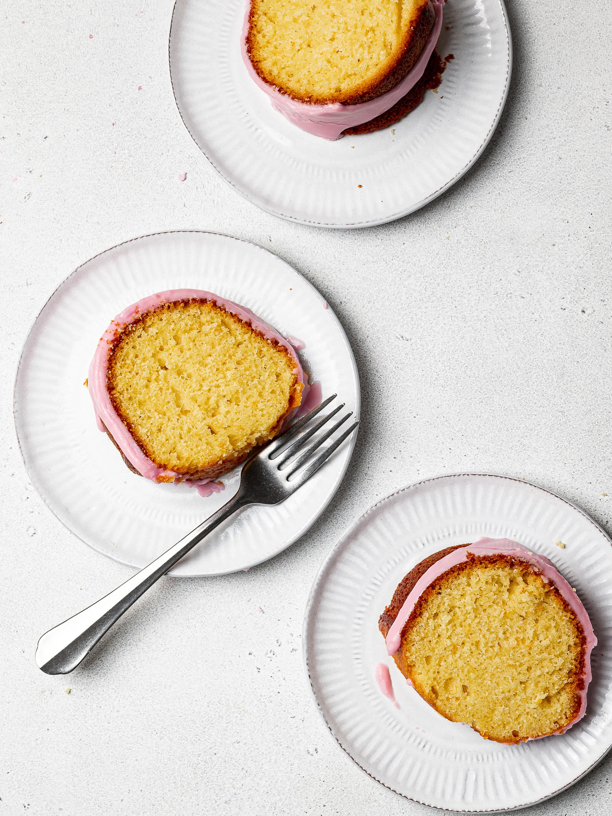 three slices of olive oil and yogurt cake on plates