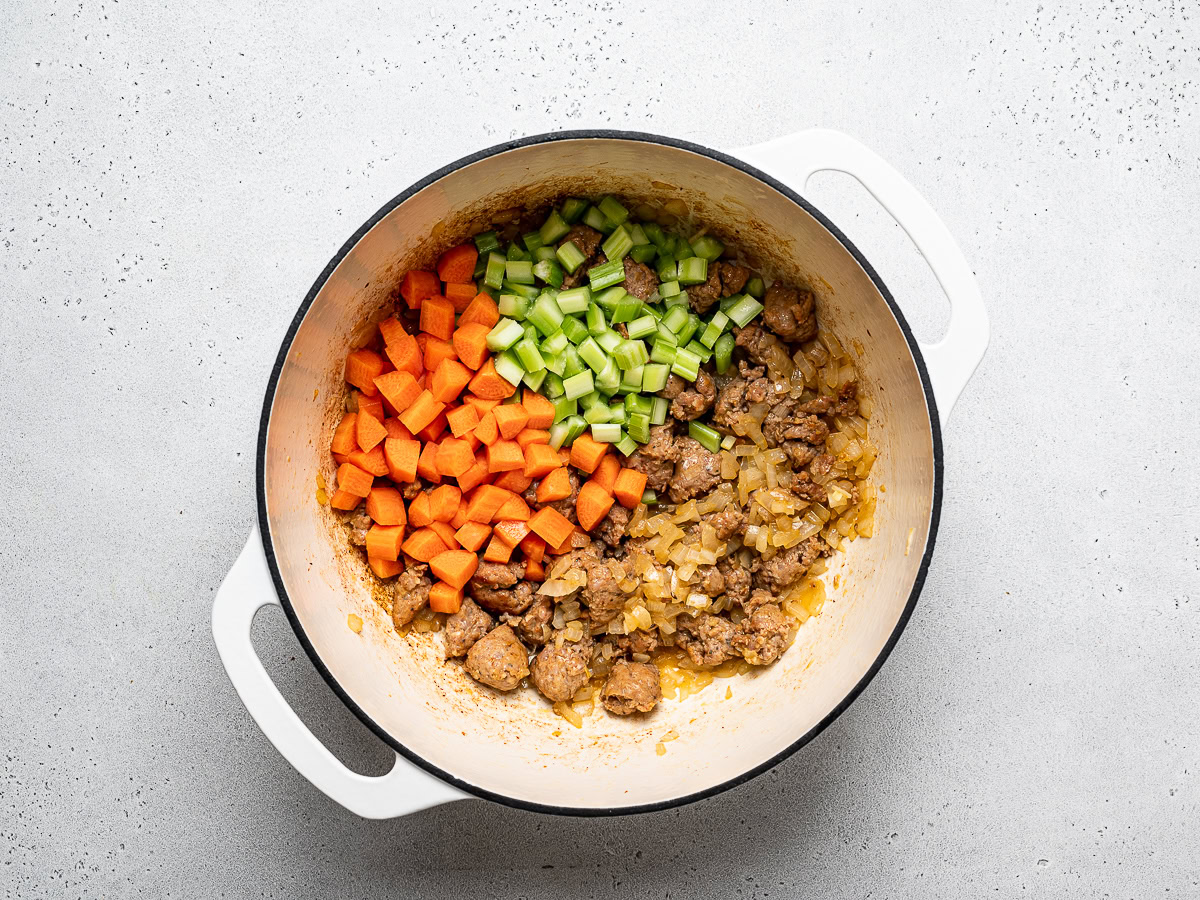 sausage and veggies cooking in dutch oven