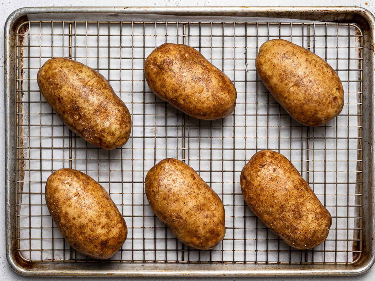 wet and salted russet potatoes on wire rack 