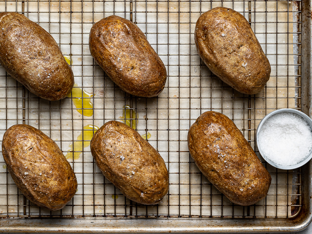 baked potatoes on wire rack with another sprinkle of salt 