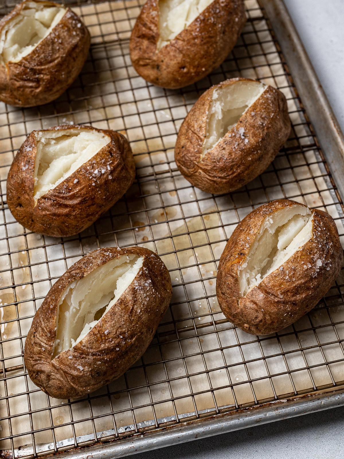 baked potatoes on Wye rack slit open on top