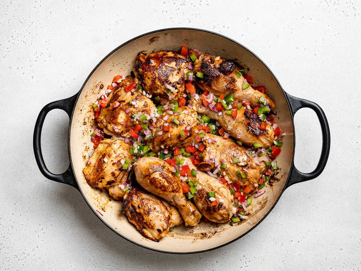 browned chicken in skillet sprinkled with remaining marinade