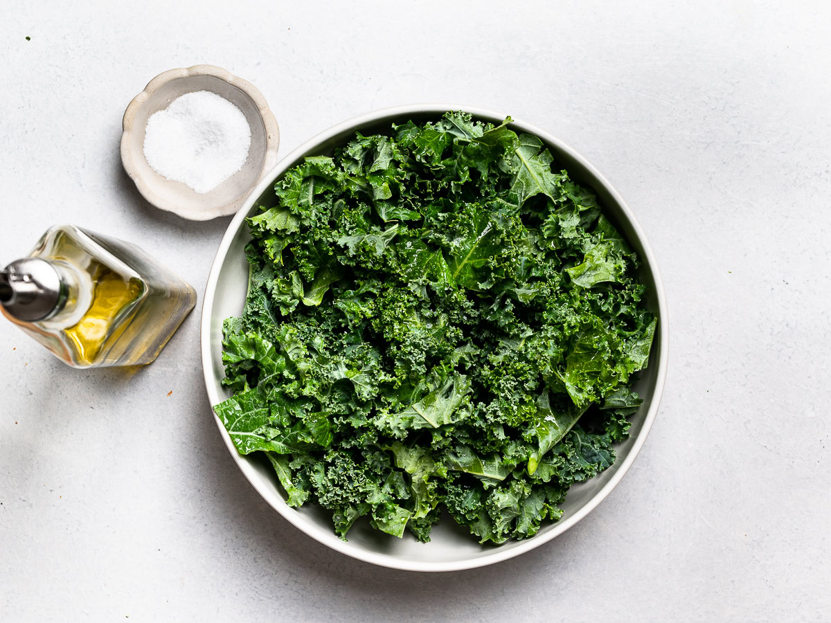 copped kale leaves in a bowl before getting massaged