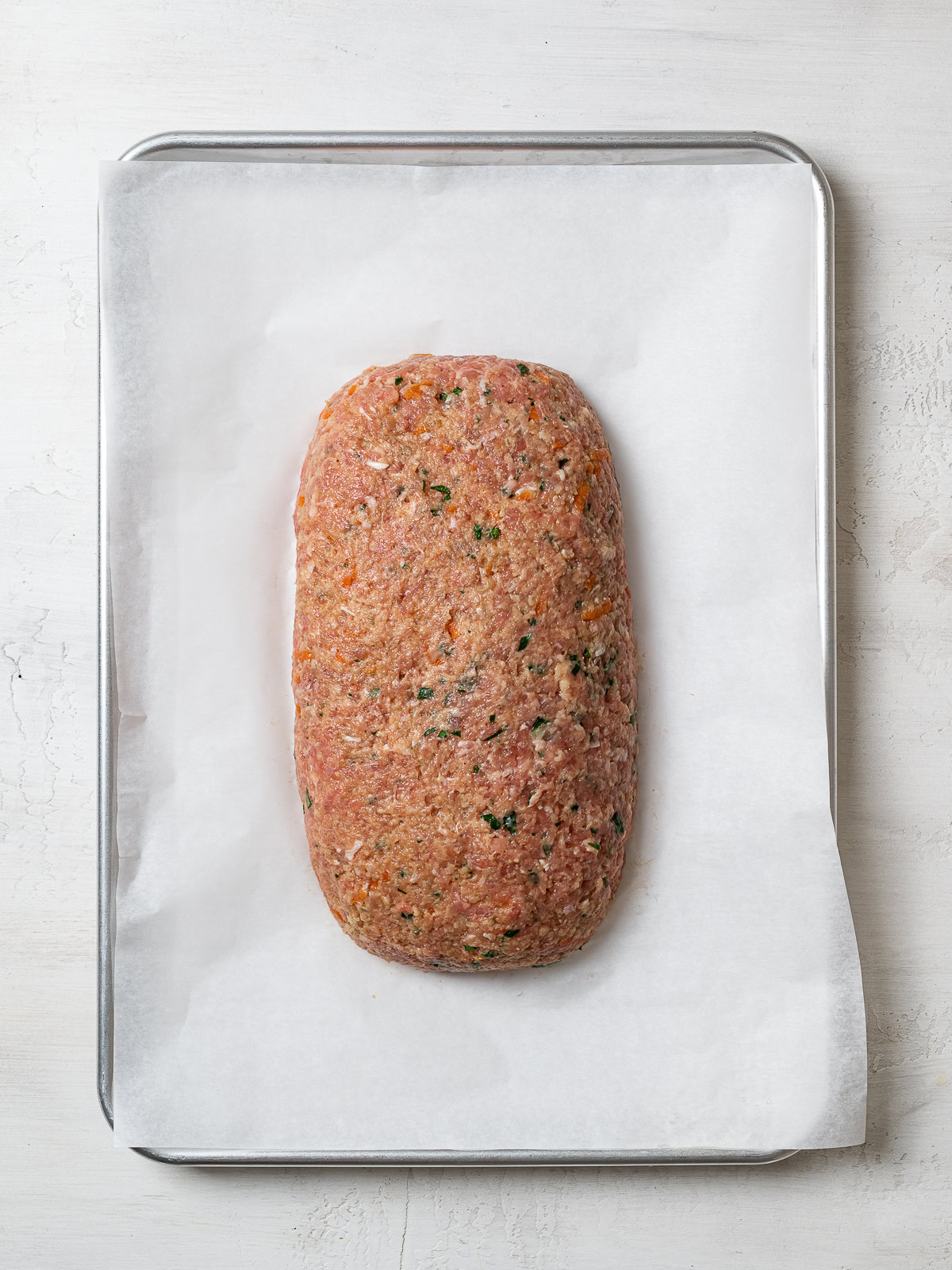 unbaked loaf shaped on baking sheet 