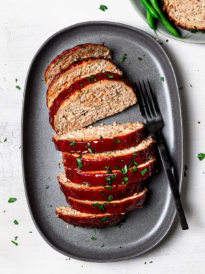 turkey meatloaf slices on platter with black fork for serving