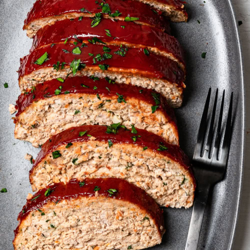 turkey meatloaf slices on platter with black fork for serving