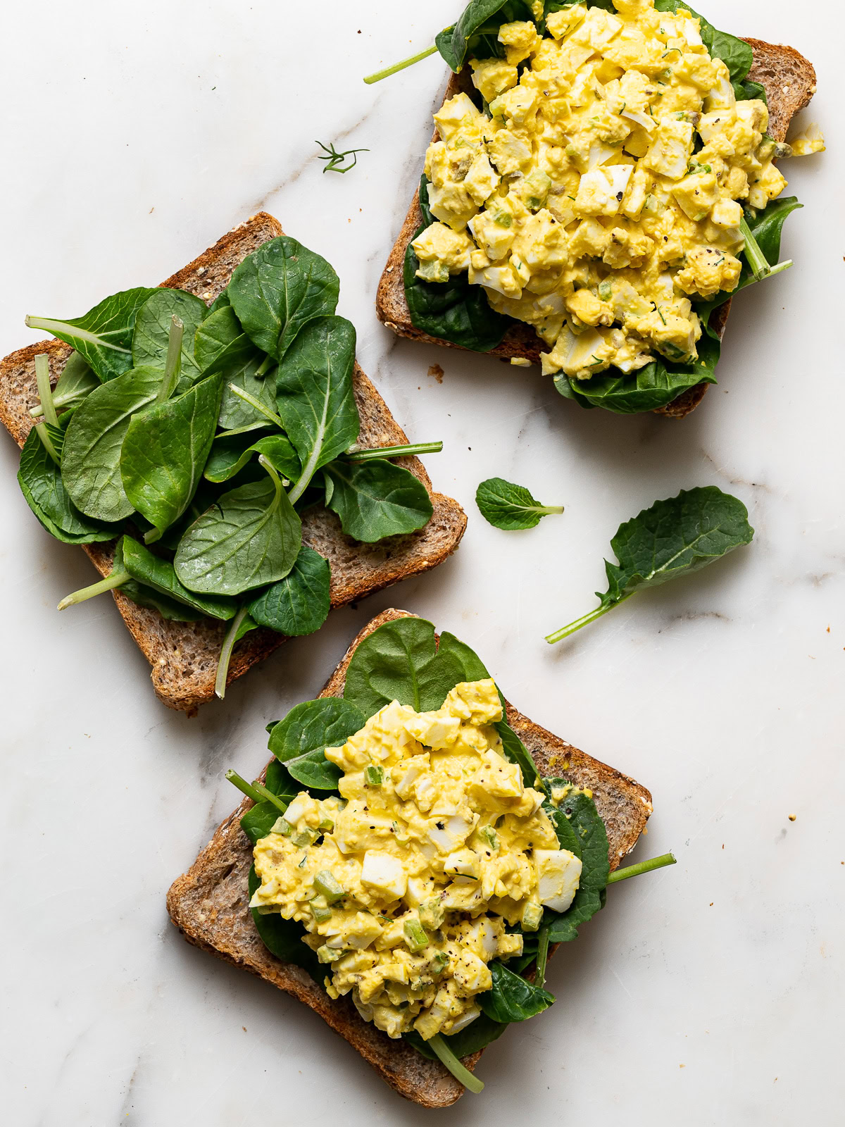 3 bread slices topped with egg salad