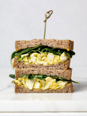 front view of a sliced egg salad sandwich