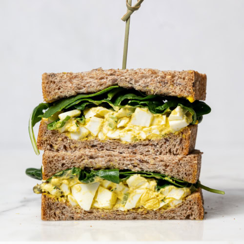 front view of a sliced egg salad sandwich