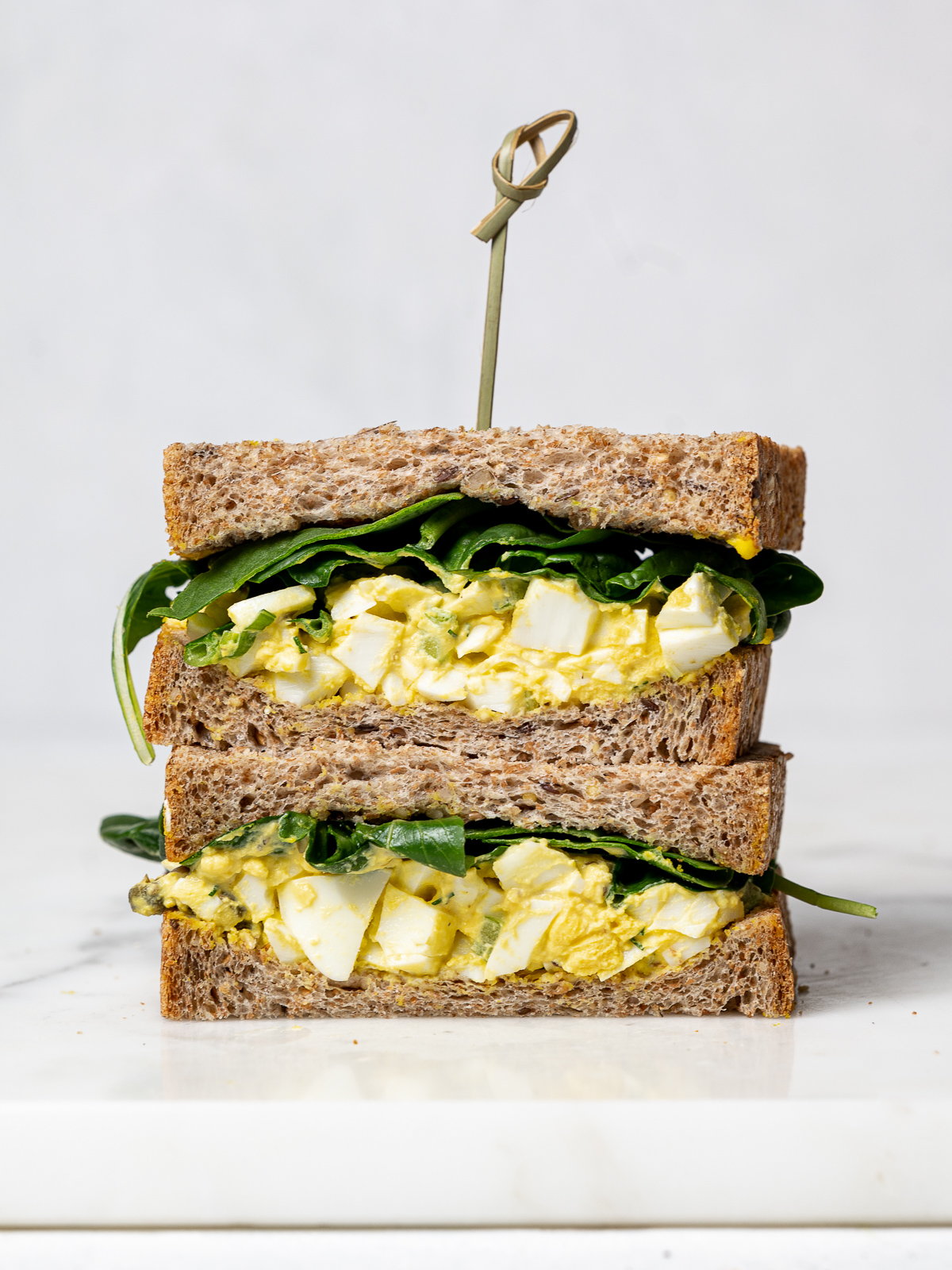 front view of a sliced egg salad sandwich 