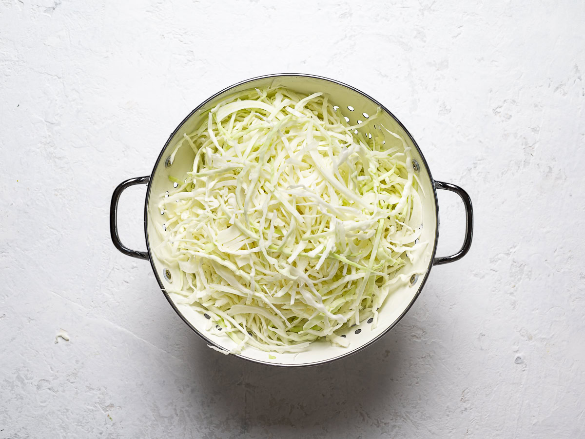 shredded cabbage in strainer