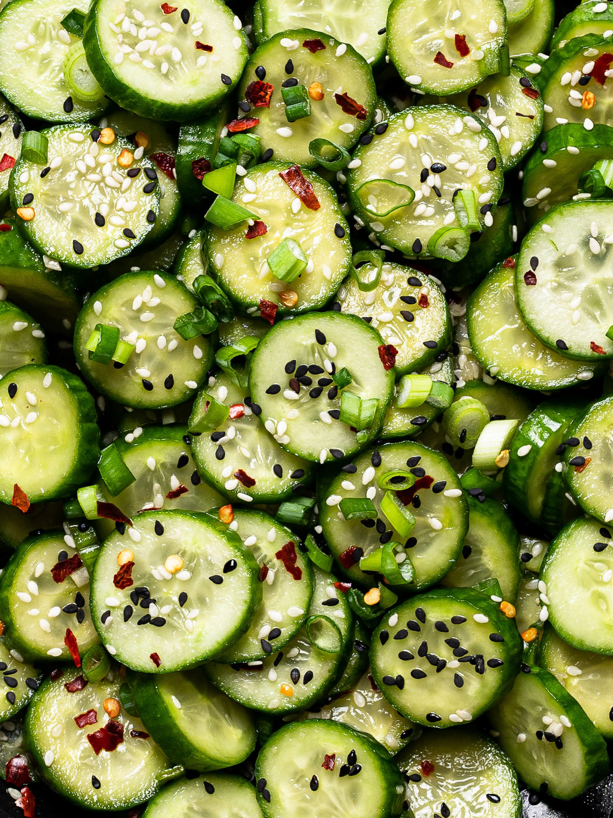 close up of Sesame cucumber salad served in black bowl 