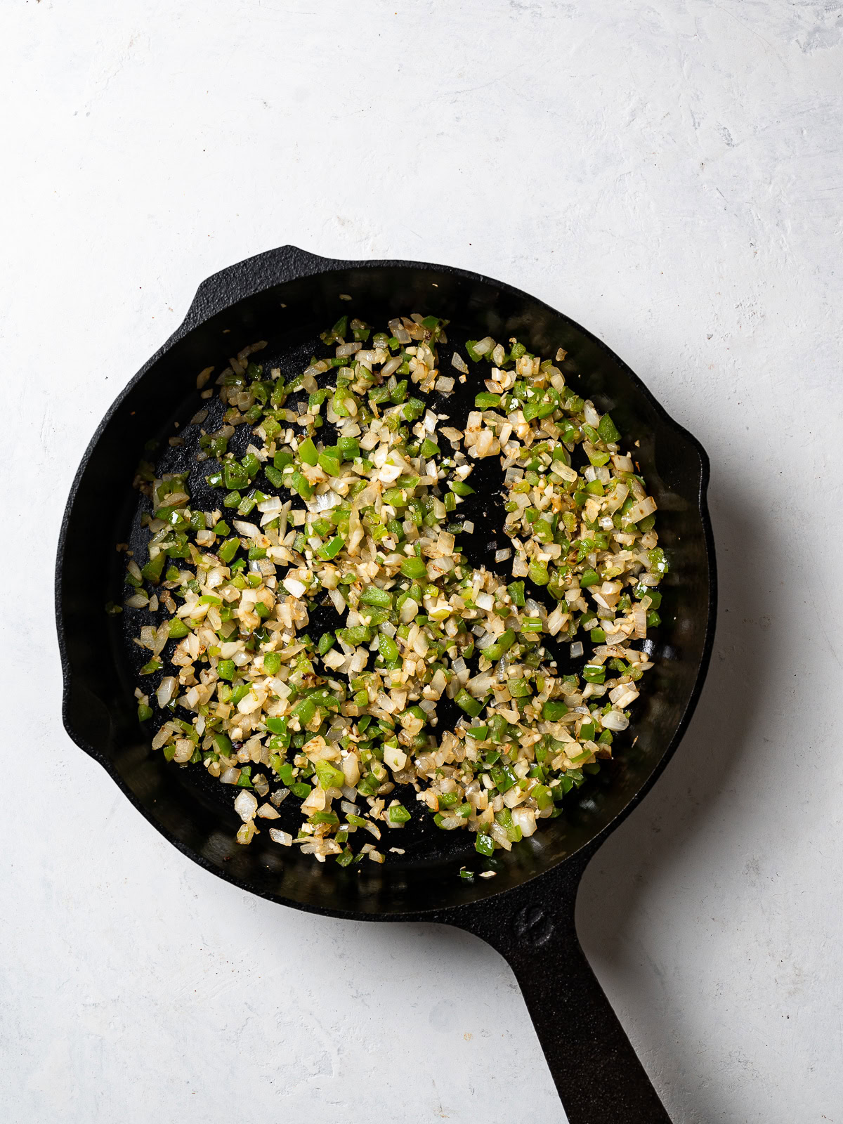 skillet with sautéed onion, green pepper, and garlic 