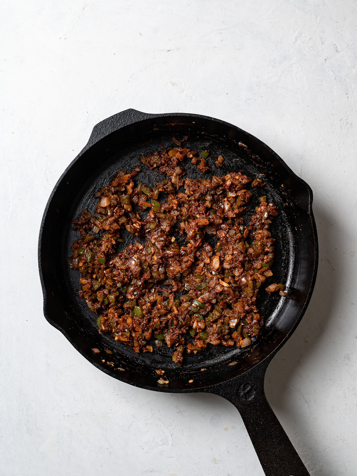 skillet with sautéed onion, green pepper, and garlic 