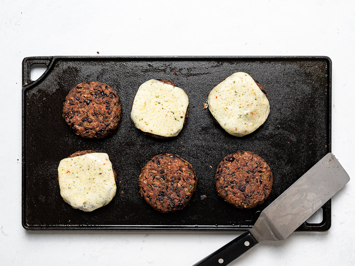 cooked black bean burgers on griddle pan