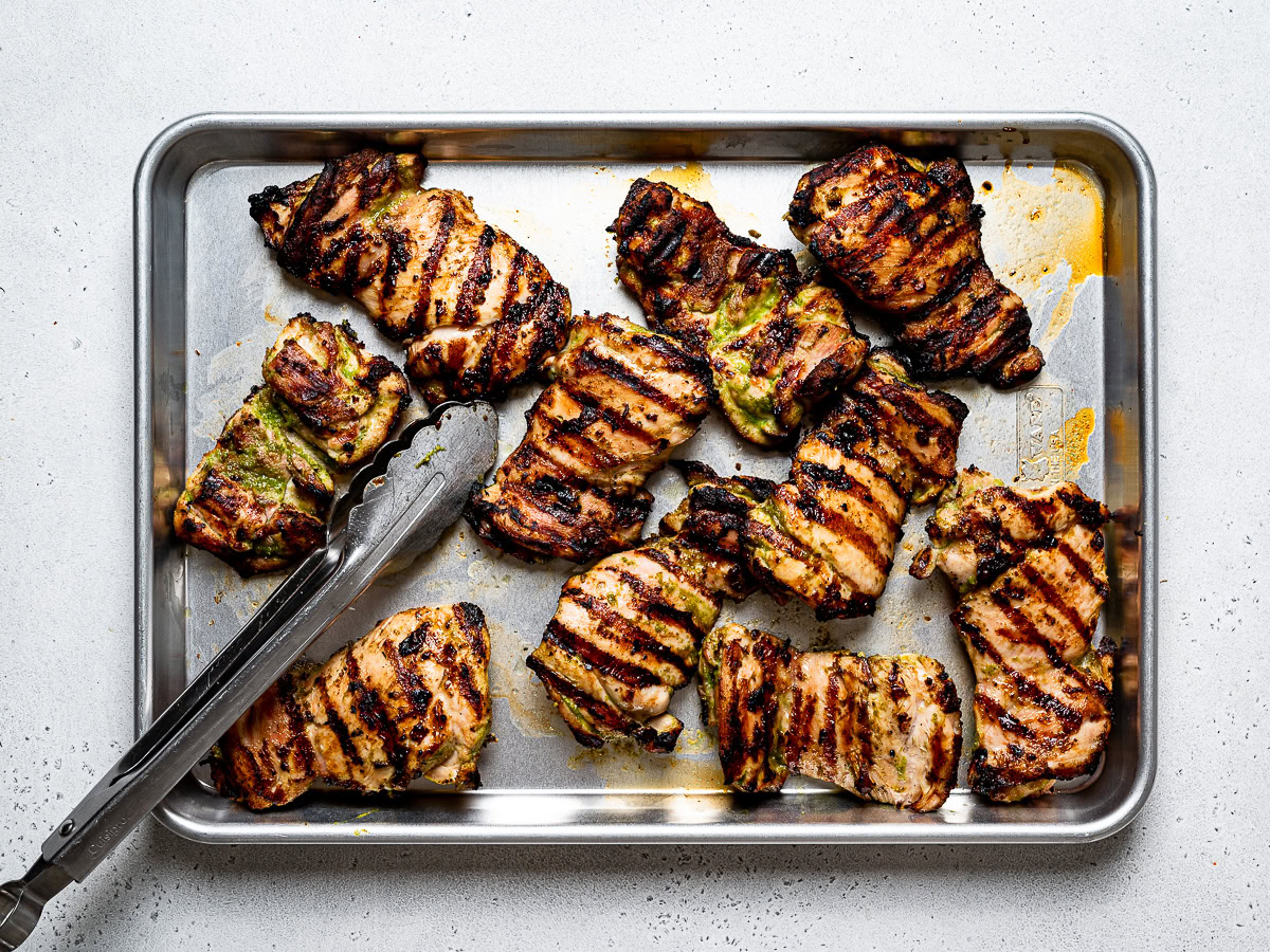 grilled chicken thighs on baking sheet