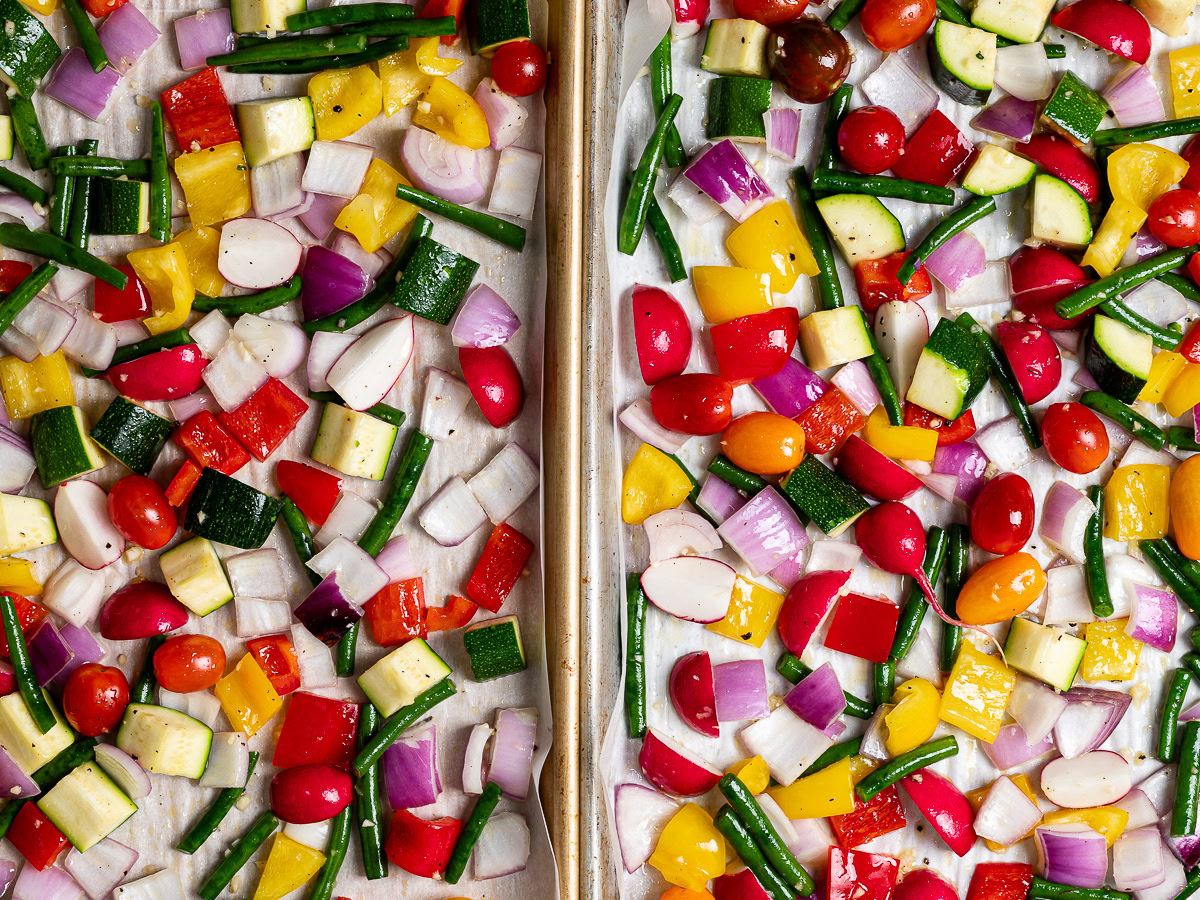 raw vegetables divided amongst two baking sheets