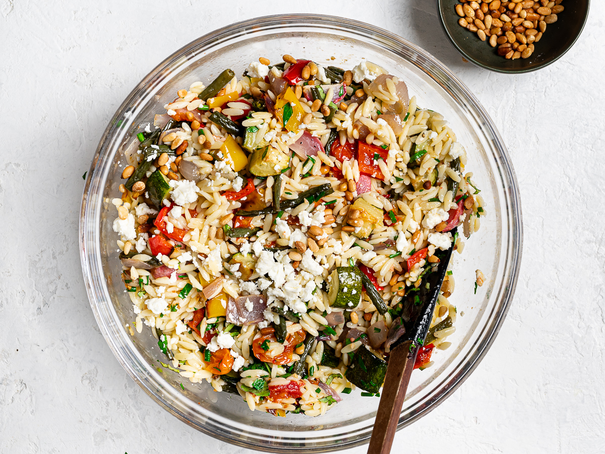 orzo mixed with roasted veggies in bowl