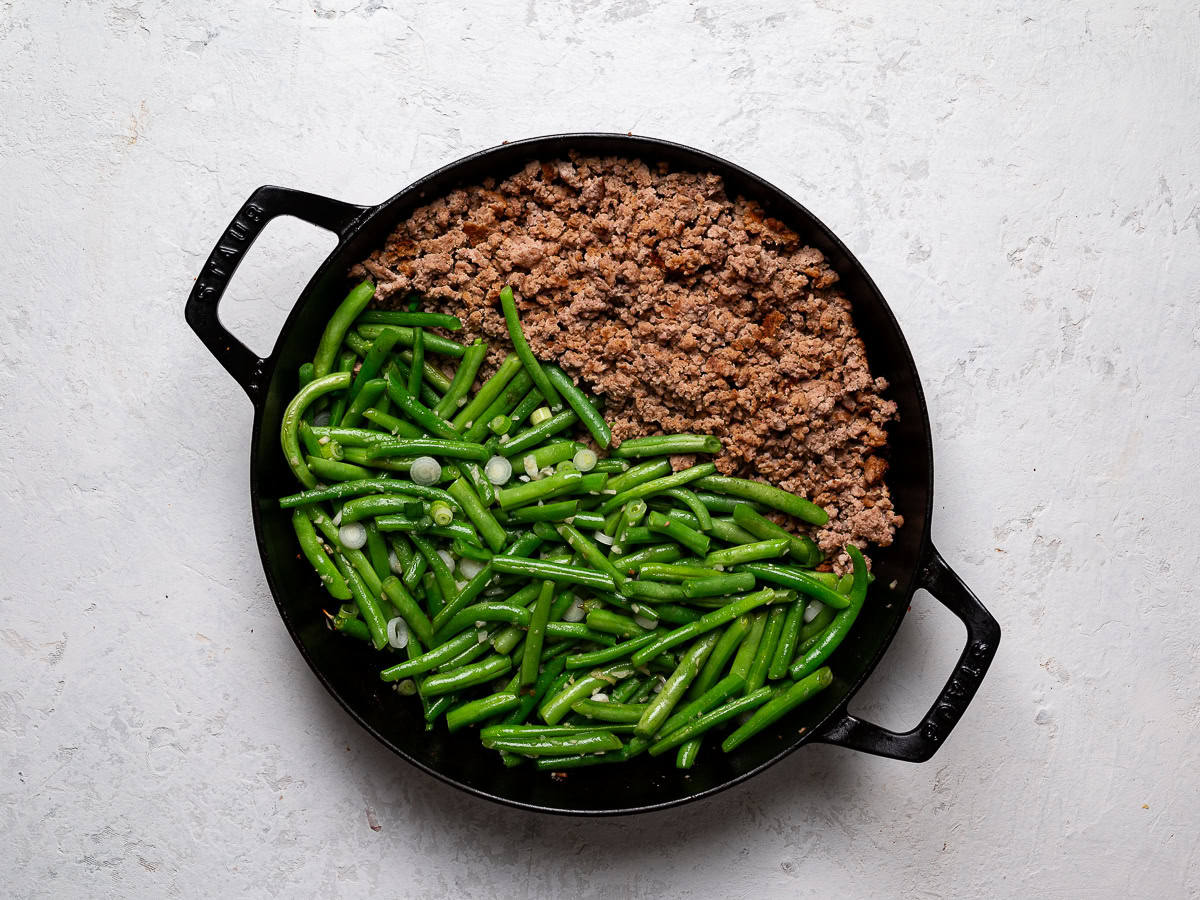 ground turkey and green beans cooking in skillet