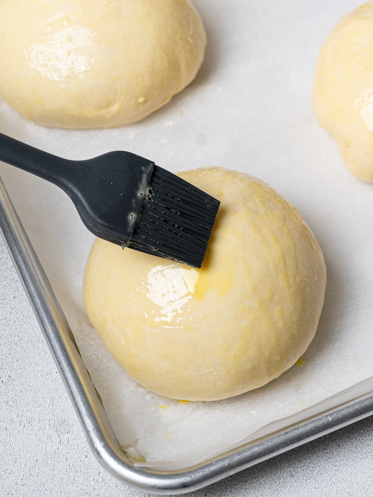 brushing dough ball with egg wash